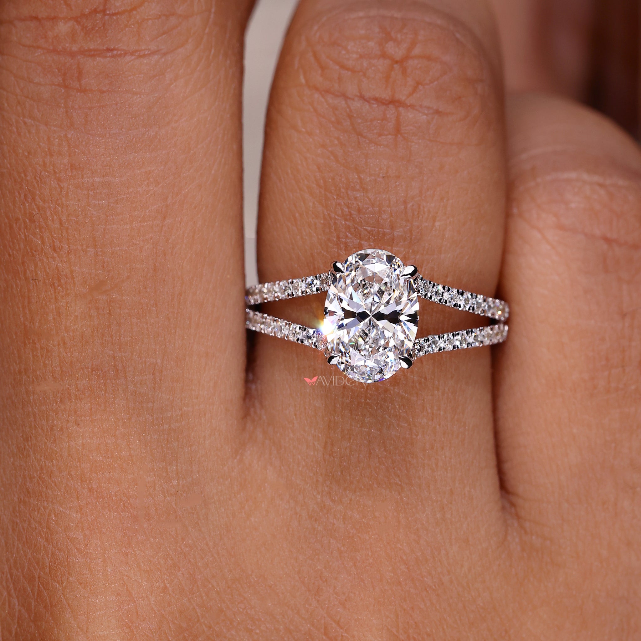 Halo oval ring engagement design with sparkling accents for a stunningly unique and timeless piece.