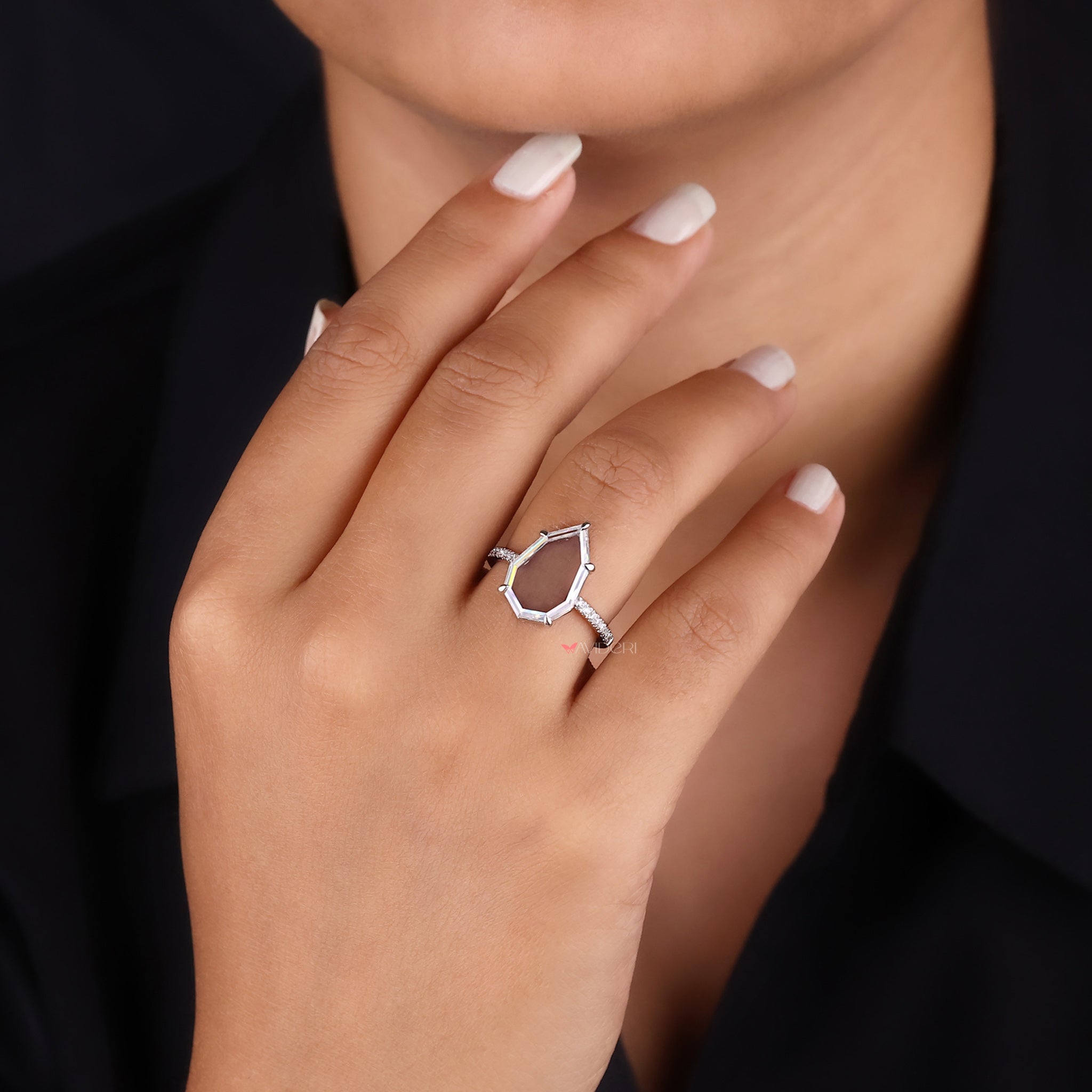 White gold engagement ring with a portrait cut center stone.