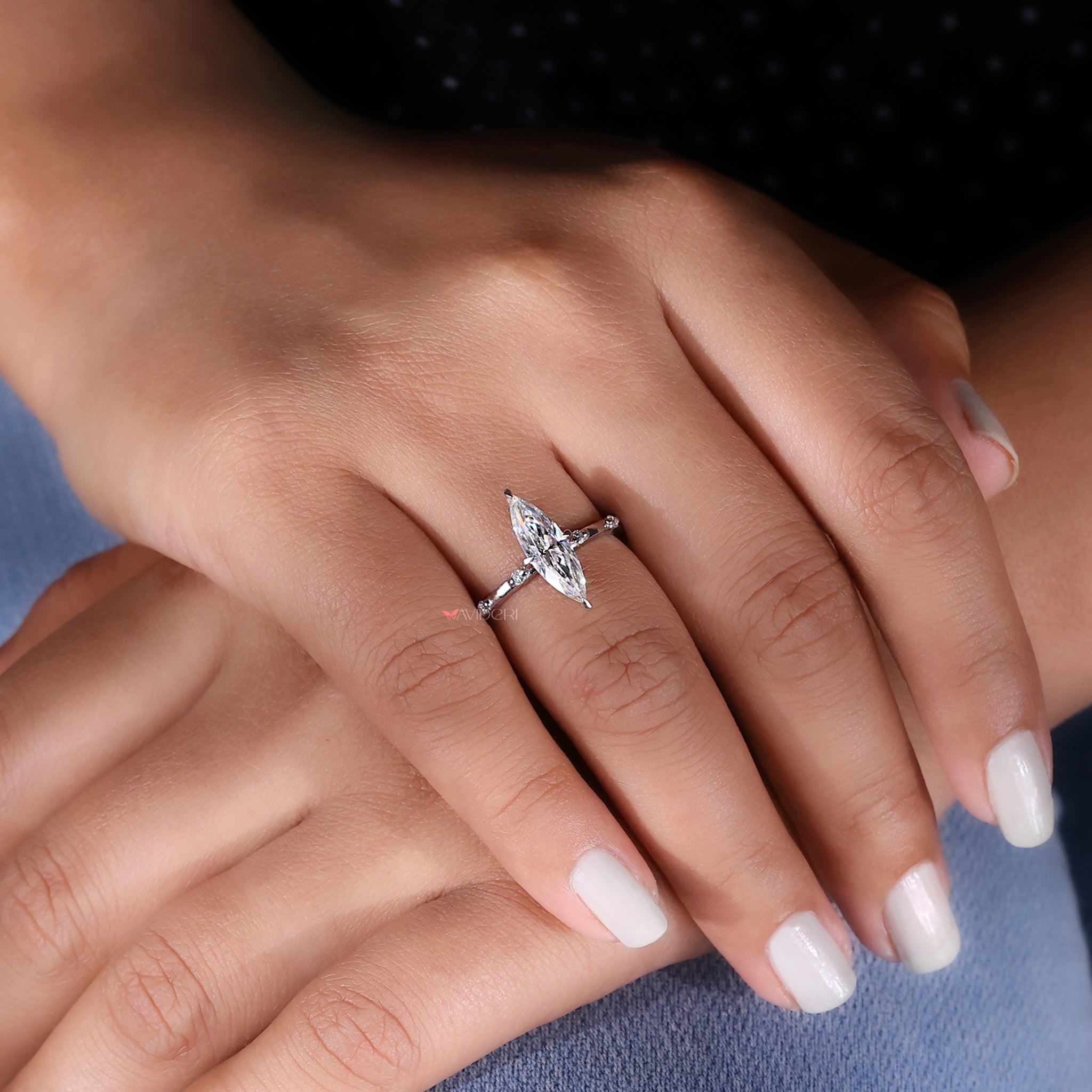 This round cut distance pave set delivers intricate sparkle with precise craftsmanship.
