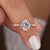A princess cut moissanite ring shown in a close-up view.
 A princess cut moissanite ring shown in a close-up view.
