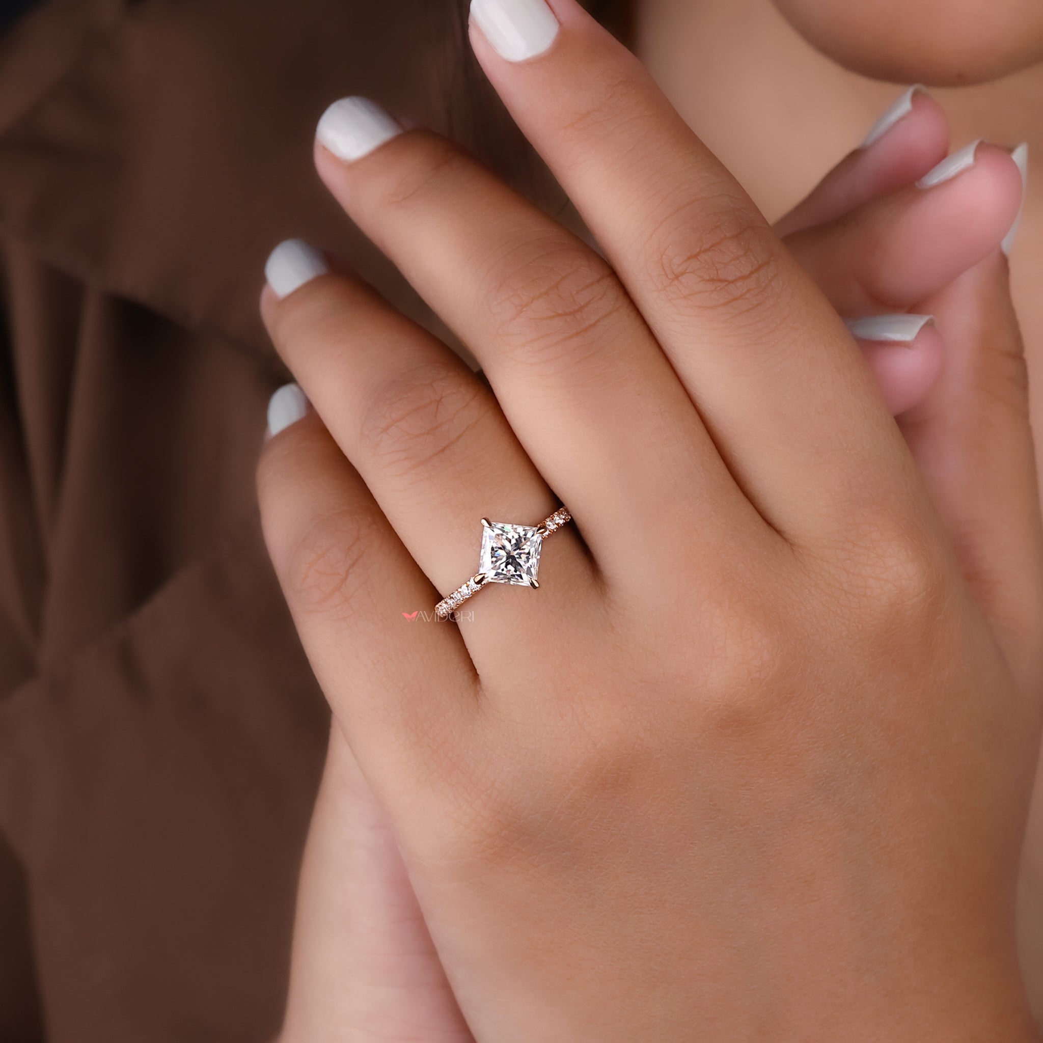 A 4 claw prong set ring securing a moissanite center stone.