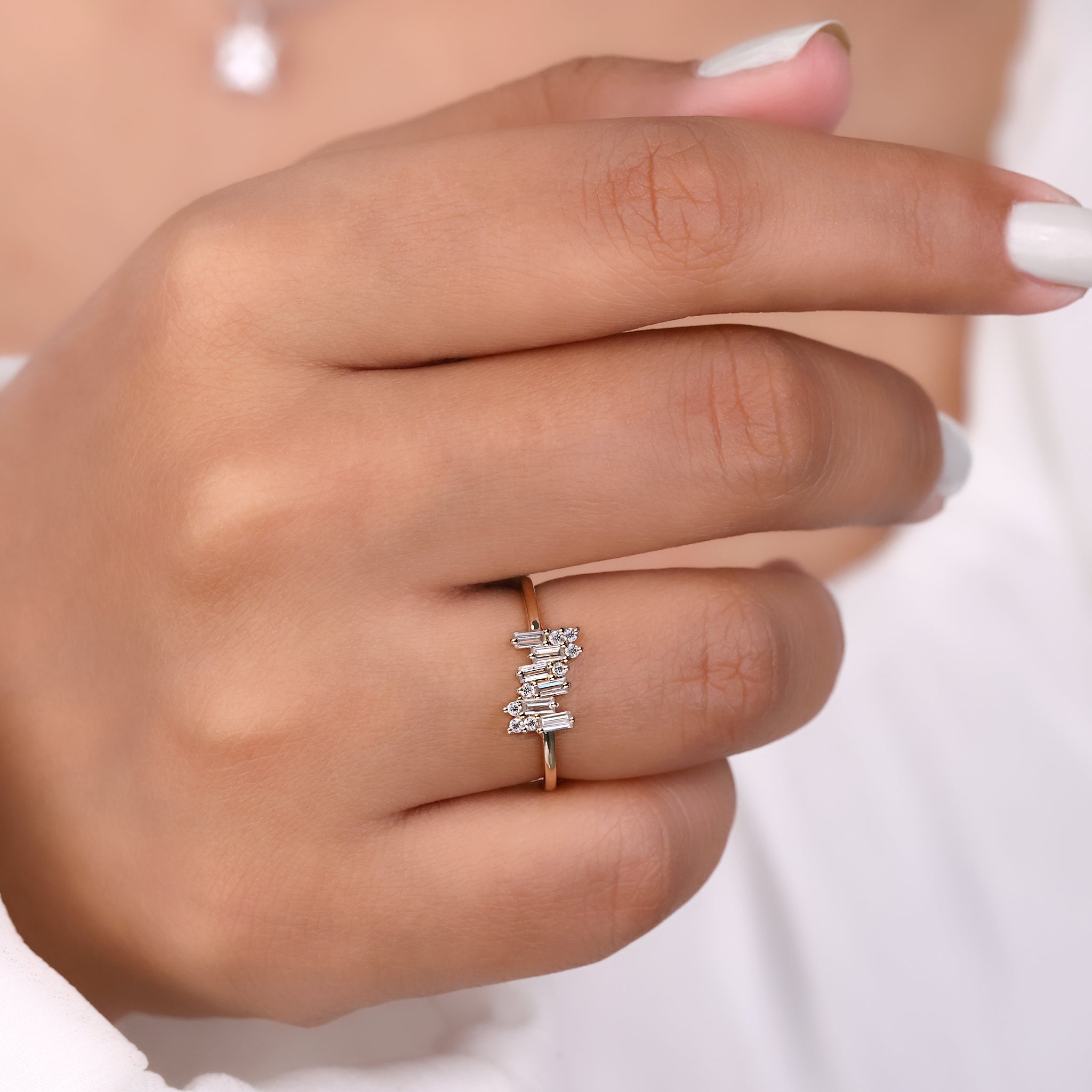 A baguette cut ring placed on a white background.
