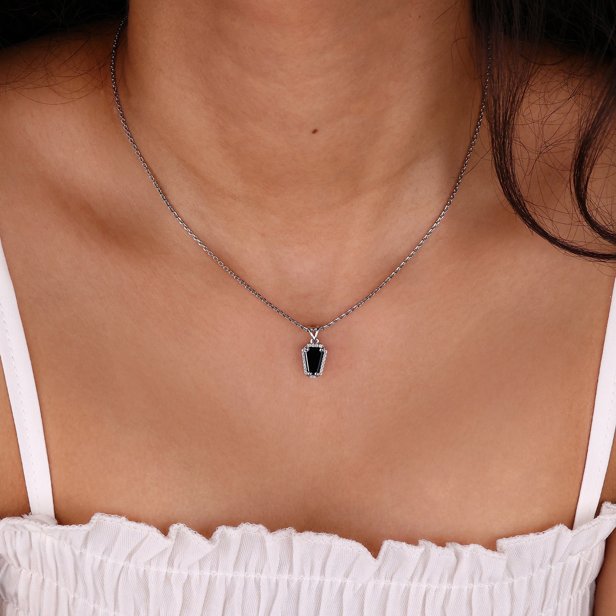 Custom moissanite pendant set in a coffin pendant for a personalized touch.