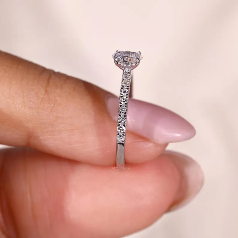 Pave ring with a round cut diamond.