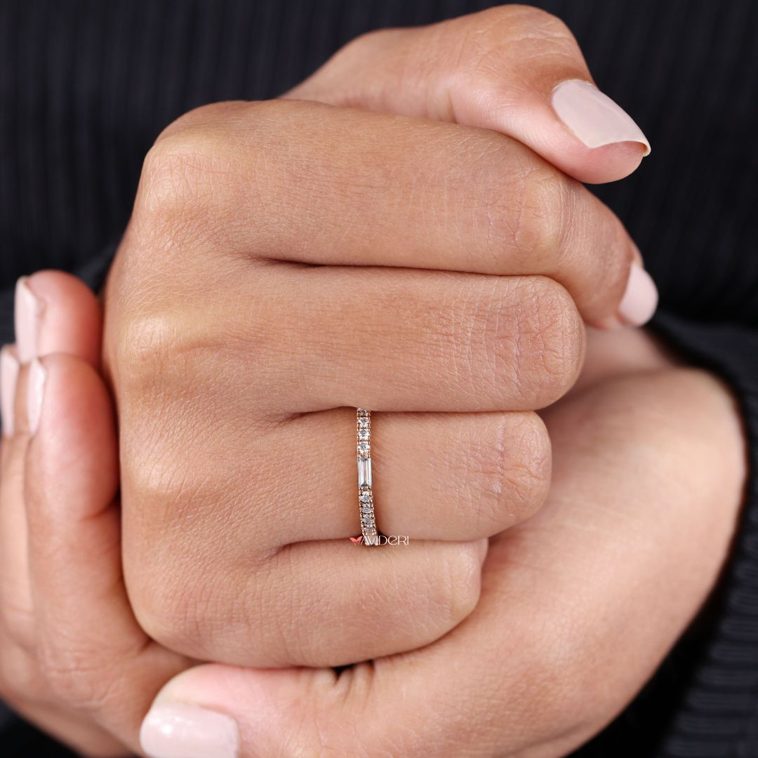 Stackable wedding ring adds layering versatility with minimalist charm.