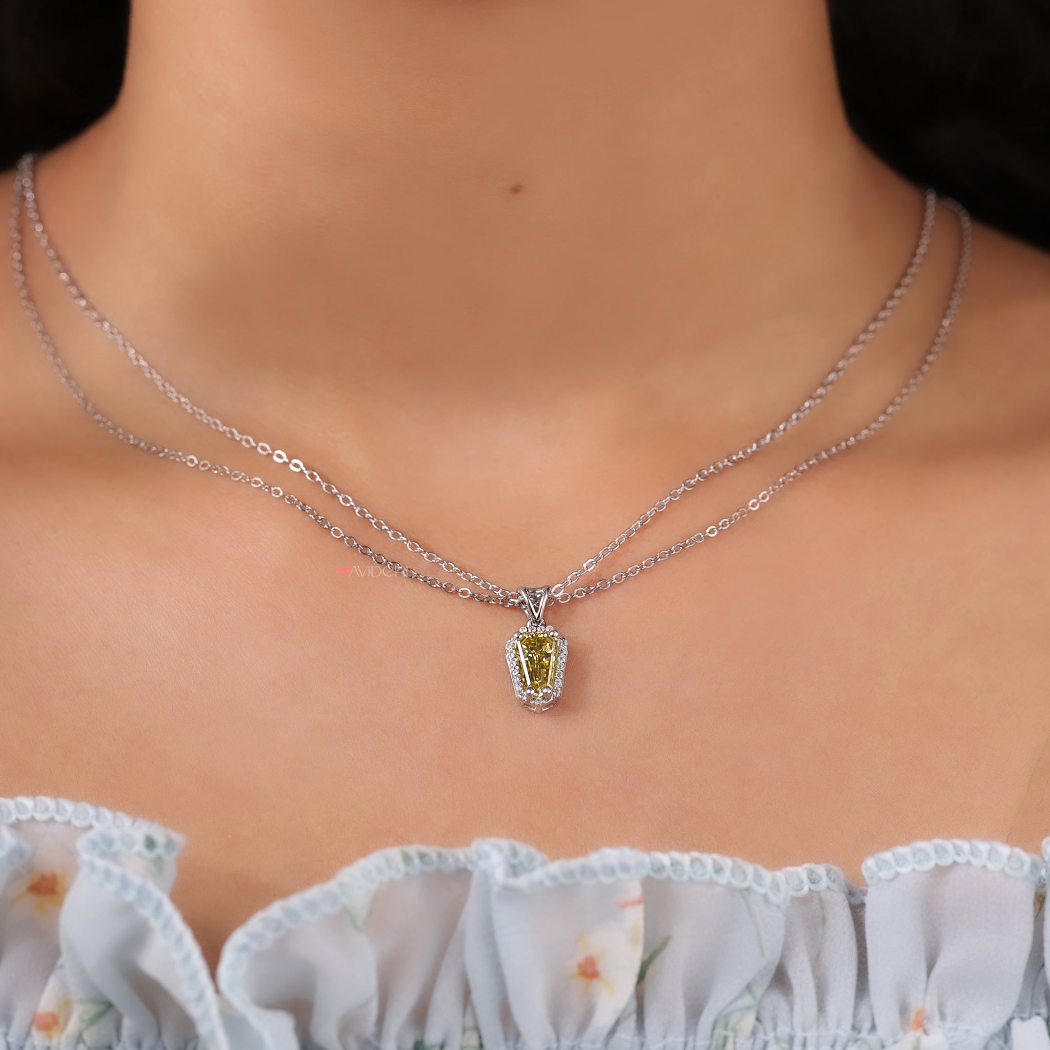 Canary Yellow shield cut pendant glows with vibrant color and unique shape.