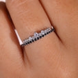 White gold wedding band featuring a round cut eternity band design.