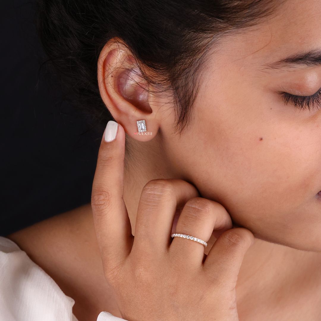 Round cut Moissanite earrings with baguette side stones for added sparkle.