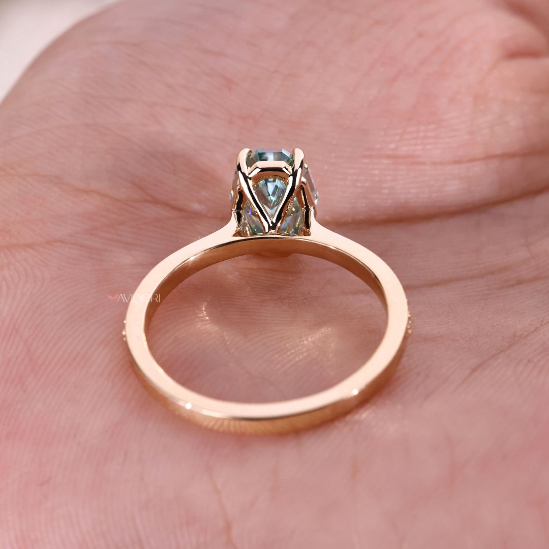 A bold Yellow gold engagement ring sits on her finger.