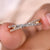 Crossover wedding band featuring brilliant diamonds.
 Crossover wedding band featuring brilliant diamonds.
