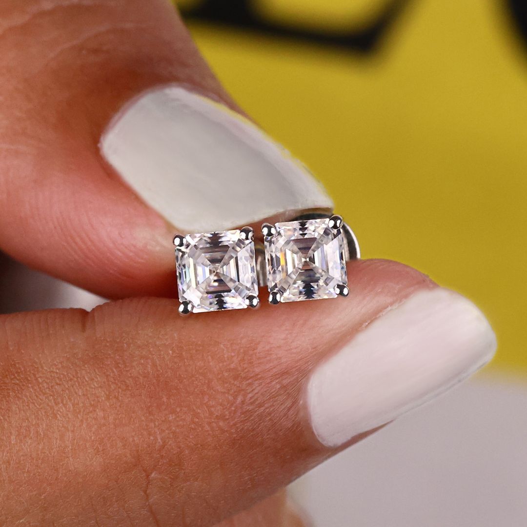 These Asscher cut earrings offer sharp angles and elegance.