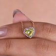 Heart-shaped pendant with moissanite halo accents.