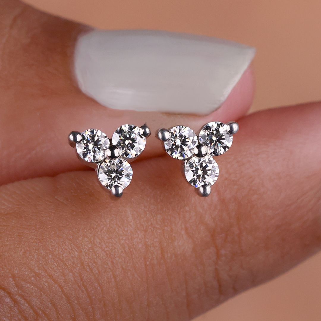 Round Cut Moissanite three stone earrings in white gold for added elegance.