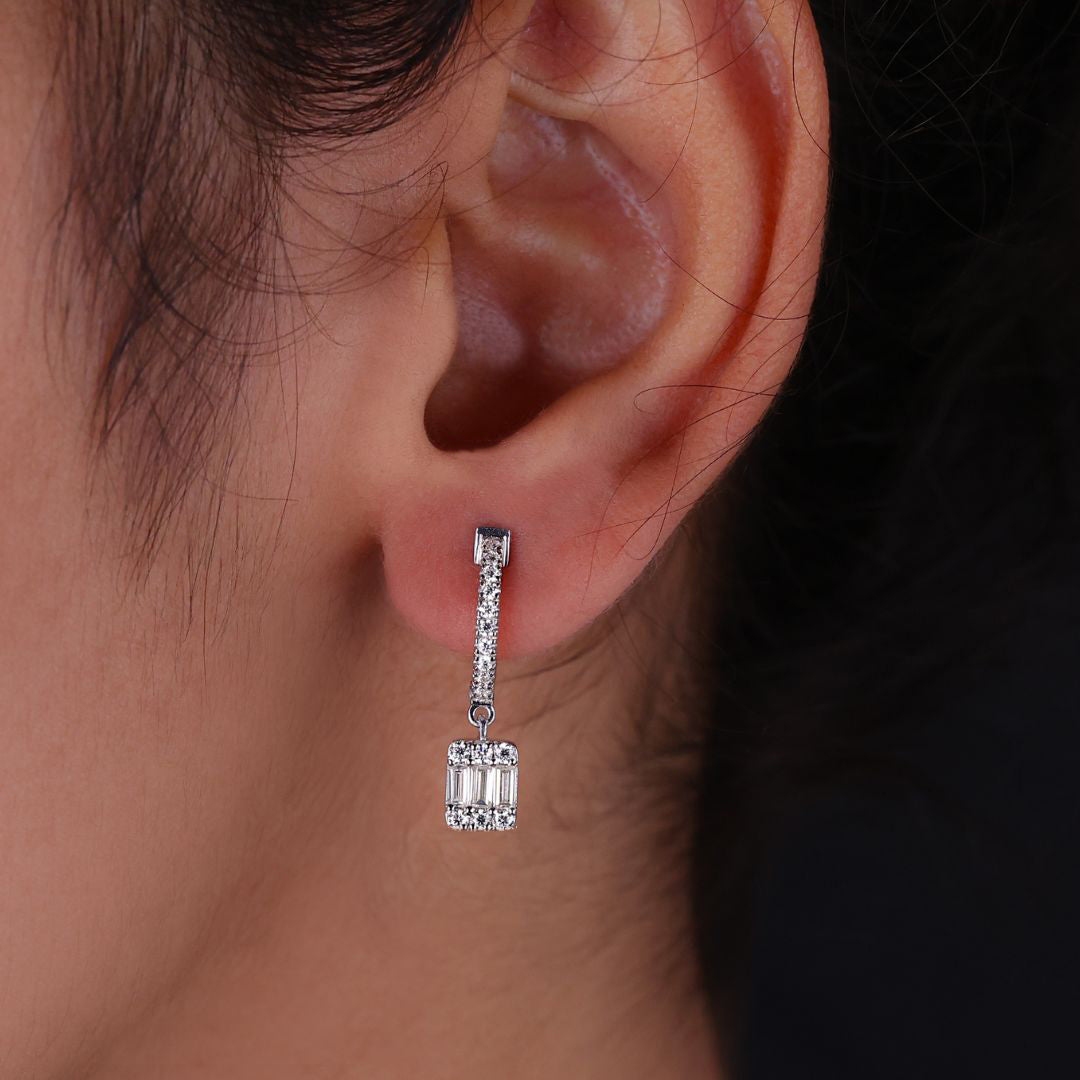 Baguette cut Moissanite dangle drop earrings in white gold for elegance.
