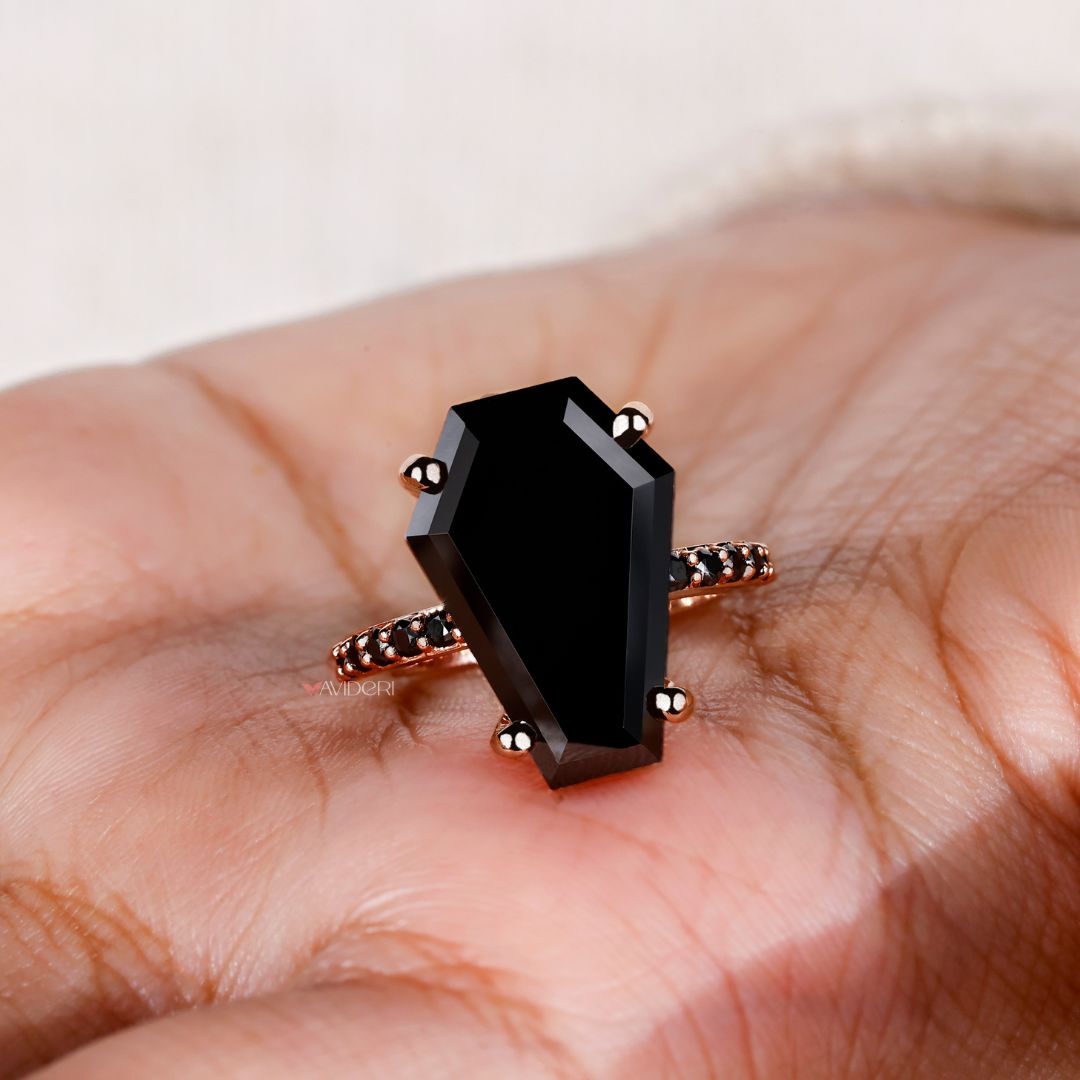 Rose gold ring with a beautiful coffin engagement ring design.