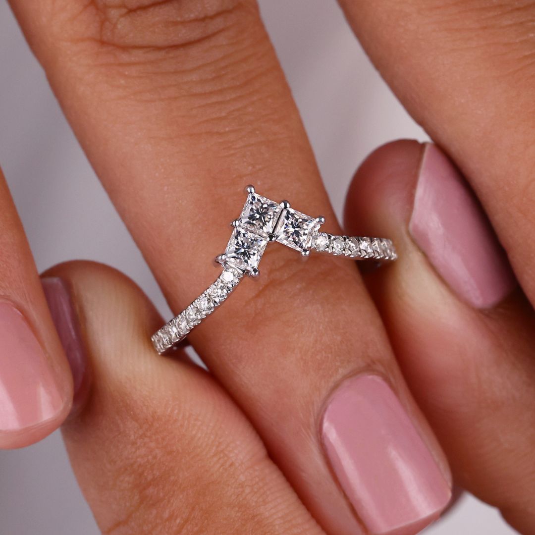 Gold chevron wedding band features a bold V-shape design with radiant stones in a sleek setting.