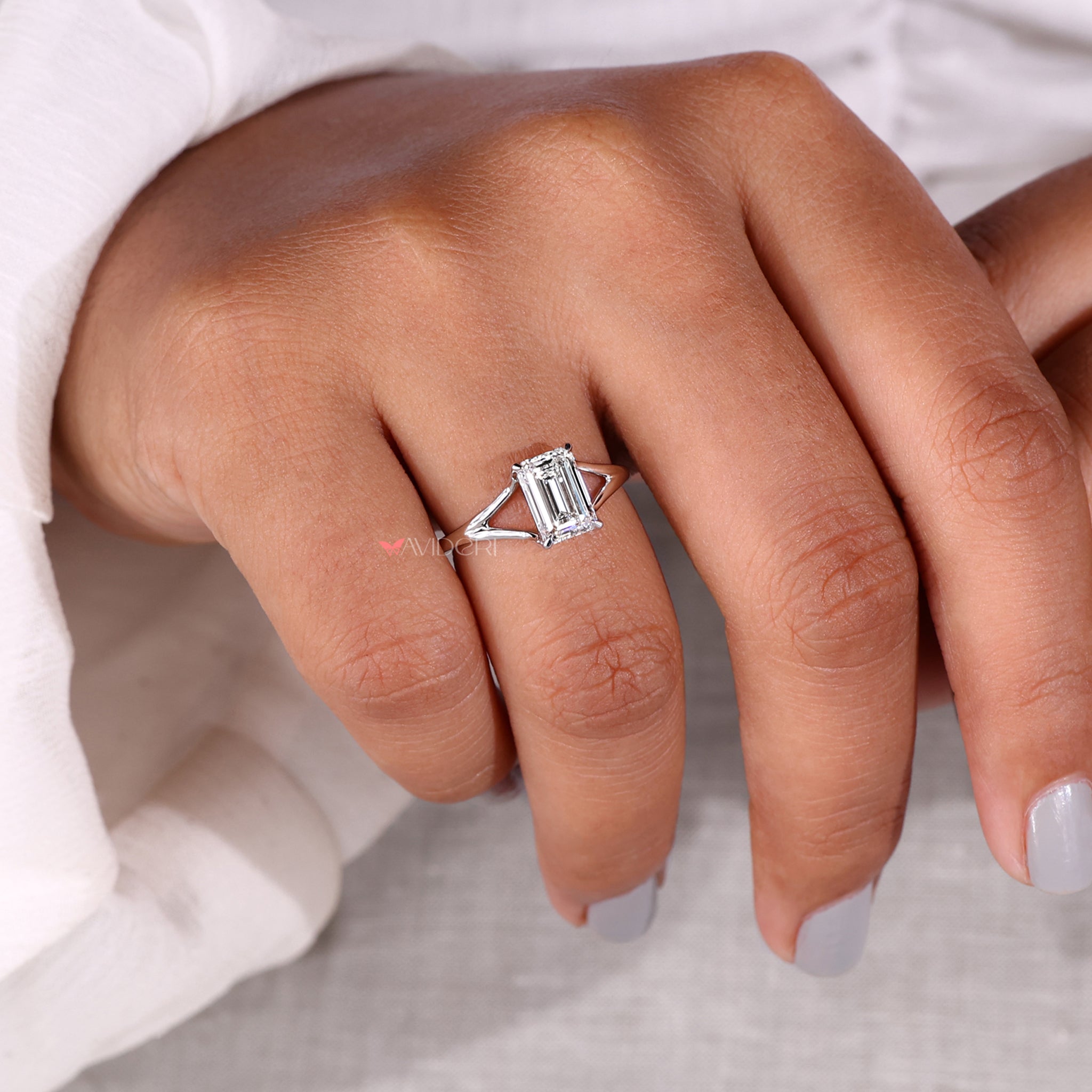IGI certified emerald cut solitaire diamond ring with split shank engagement ring style, ideal for proposals and anniversaries.