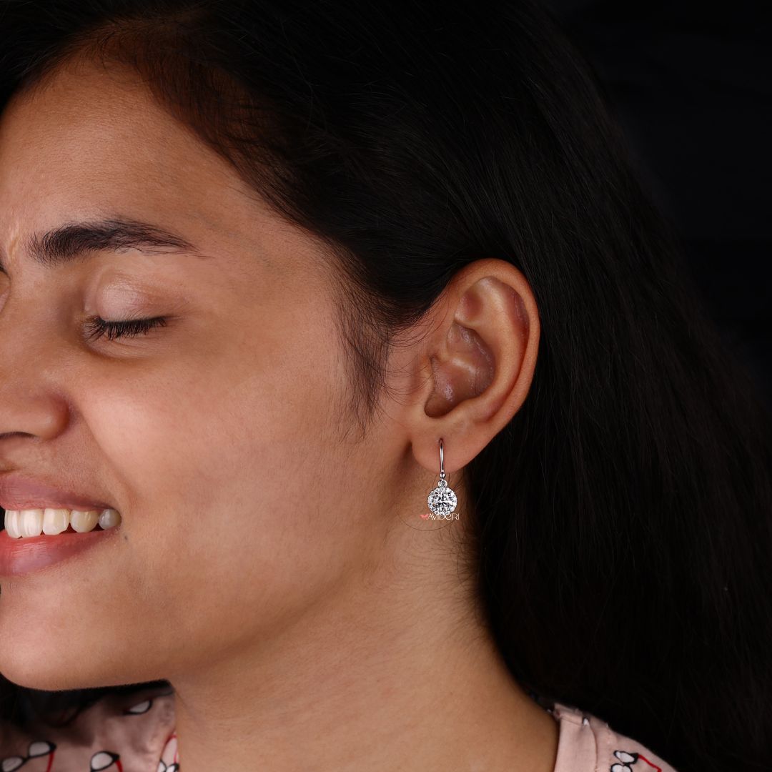 Round cut Moissanite earrings with halo design for an elegant touch.