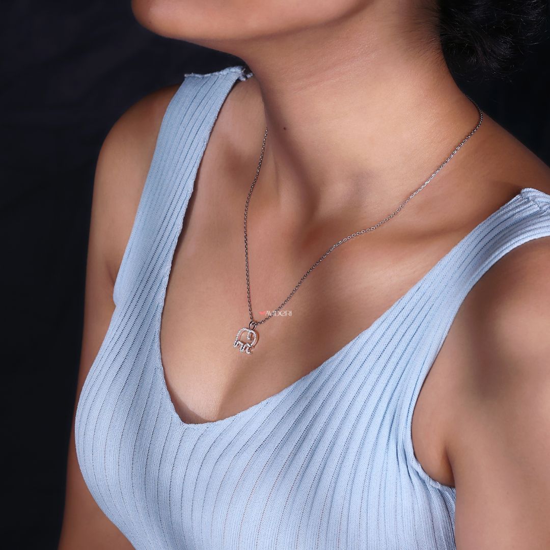 Round cut pendant featuring an elephant design.