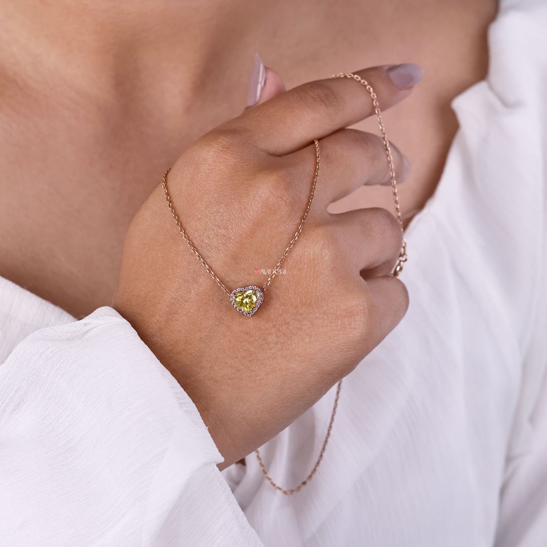 Canary yellow pendant with a heart-shaped stone center.