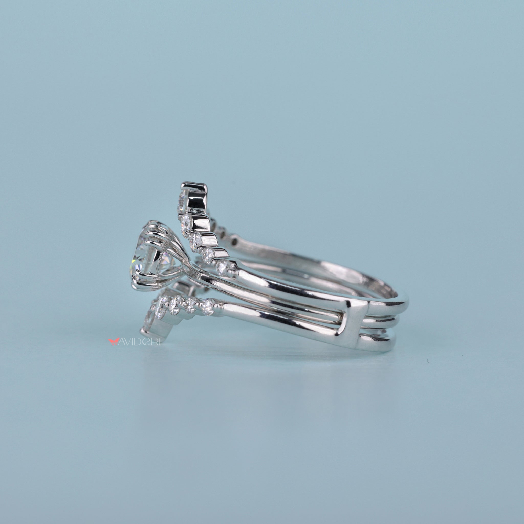 Handmade bridal set featuring a round cut solitaire with a guard wrap.