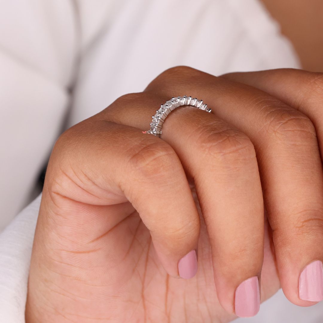 Half eternity band features partial sparkle with stones set halfway for elegant simplicity.