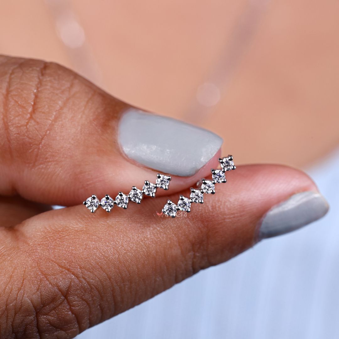 Round Arc stud earrings arranged on a soft velvet background.