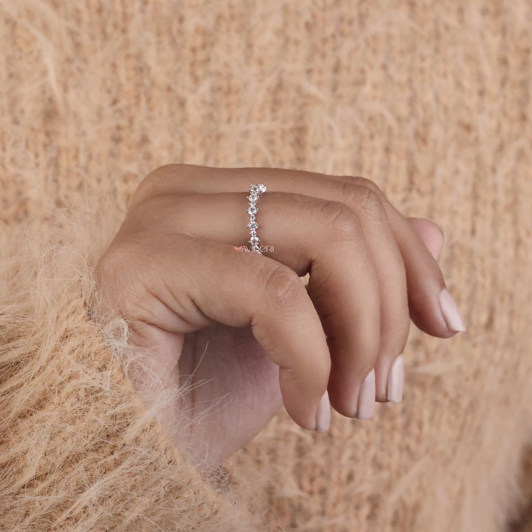 This moissanite gold wedding band is perfect for those who prefer lab-created stones in rich settings.