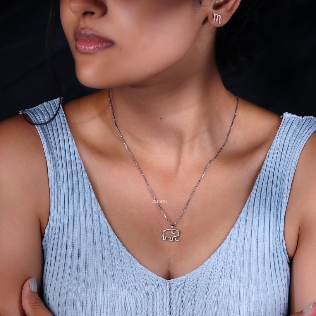 Round pendant with moissanite and elephant shape.