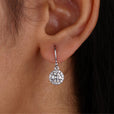Round Cut Moissanite halo earrings in white gold with prong settings.
