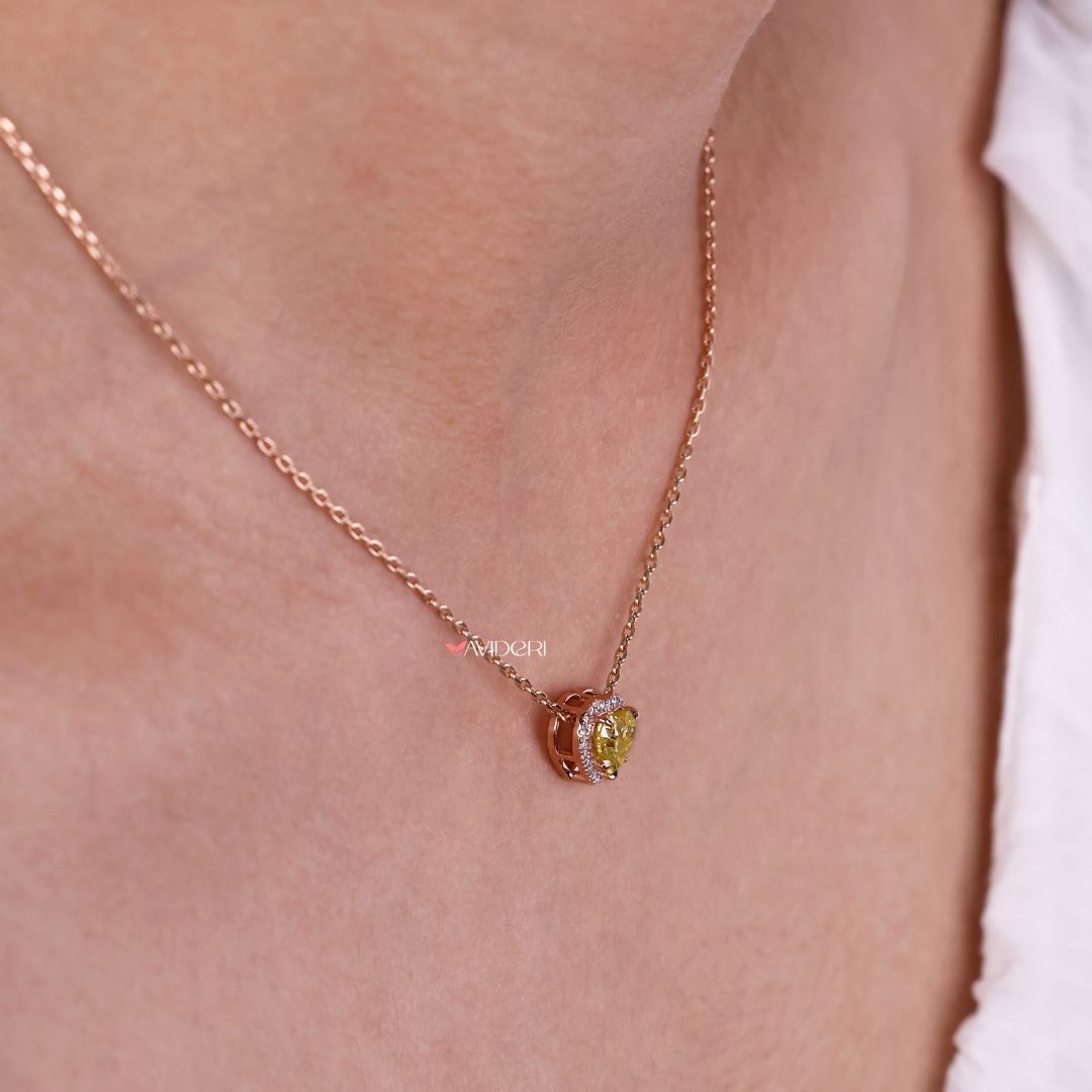 Rose gold pendant with a heart shape and stone accents.