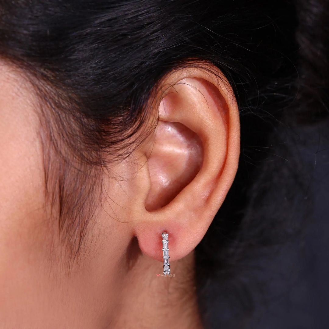 A pair of handmade white gold earrings with baguette stones