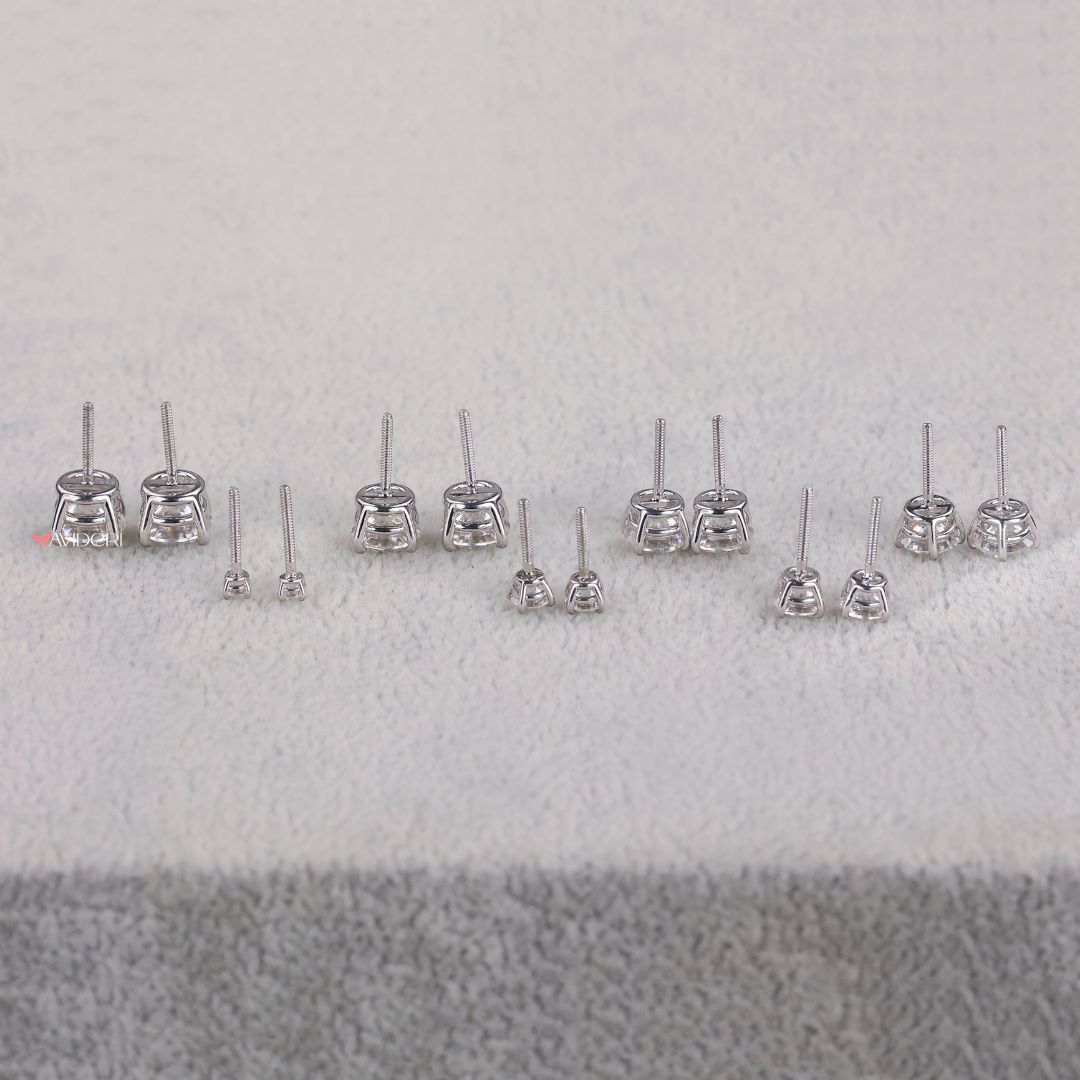 The white gold earrings give a smooth, polished look.