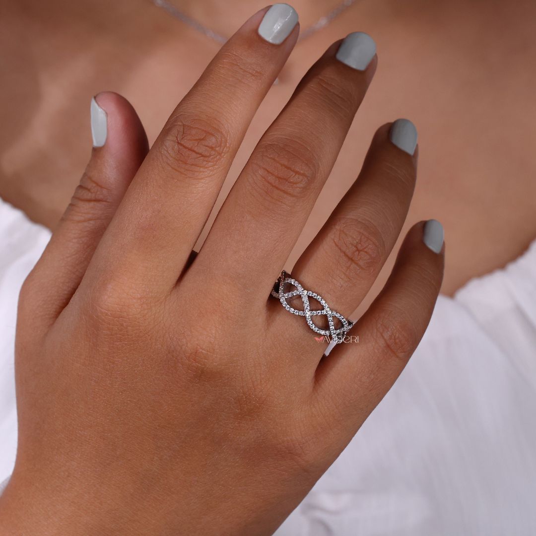 Crossover ring shaped with interlaced bands and a brilliant finish.