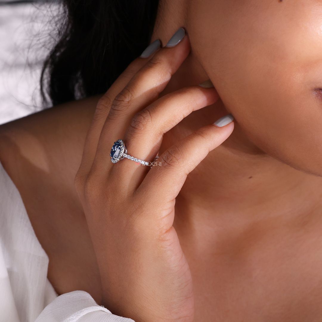 Royal dark blue engagement ring with a captivating dark blue stone.