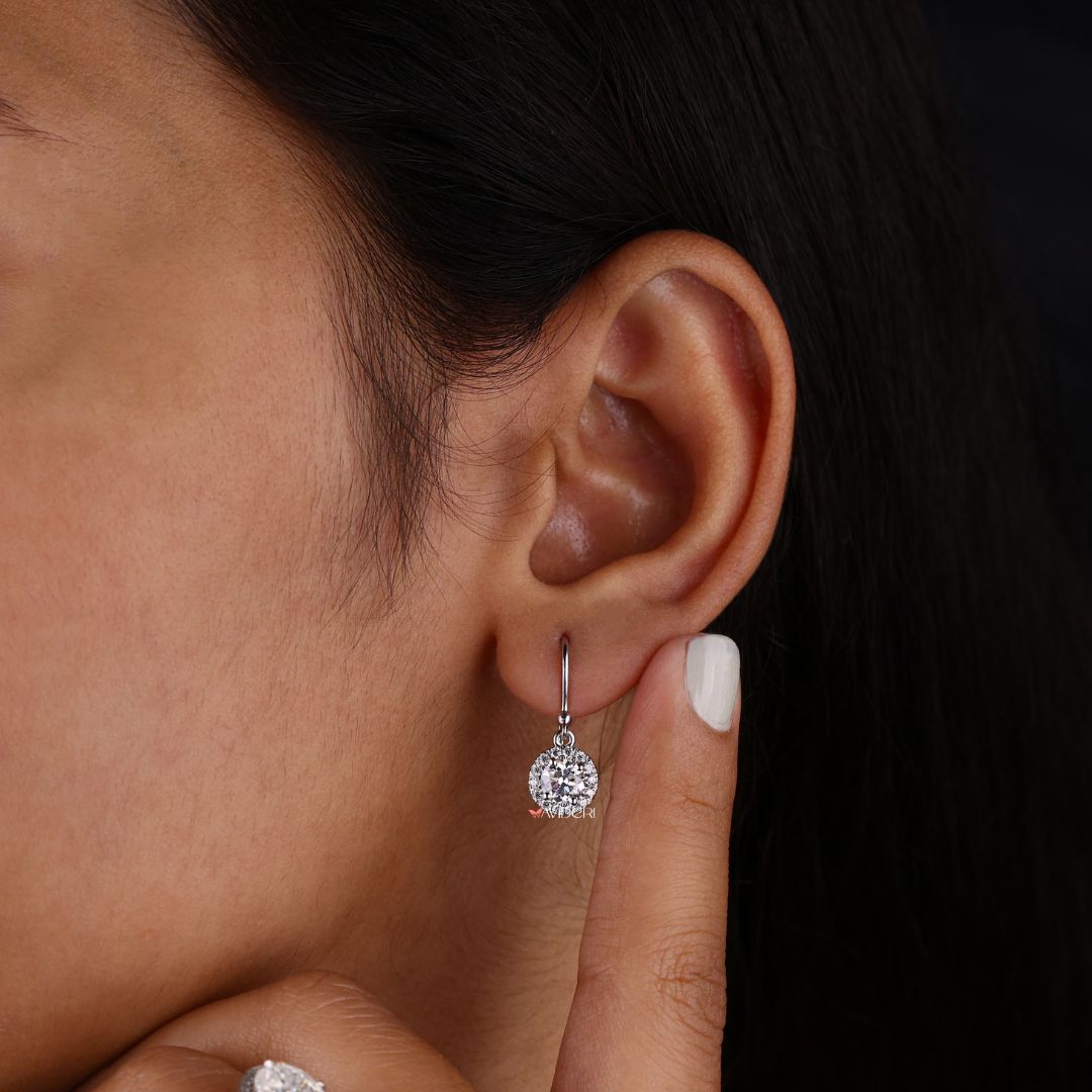 Elegant moissanite earrings with round cut in halo setting for timeless style.
