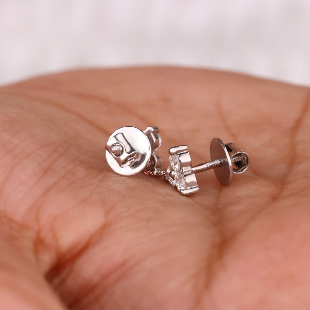 White gold earrings with prong settings and three stone round cut Moissanite.