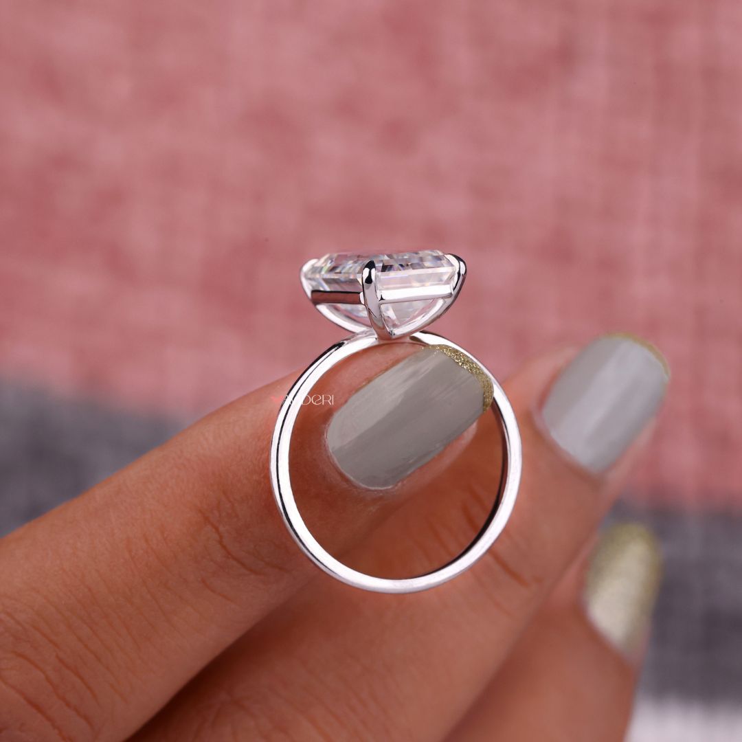 Four claw prong setting securing the moissanite stone.