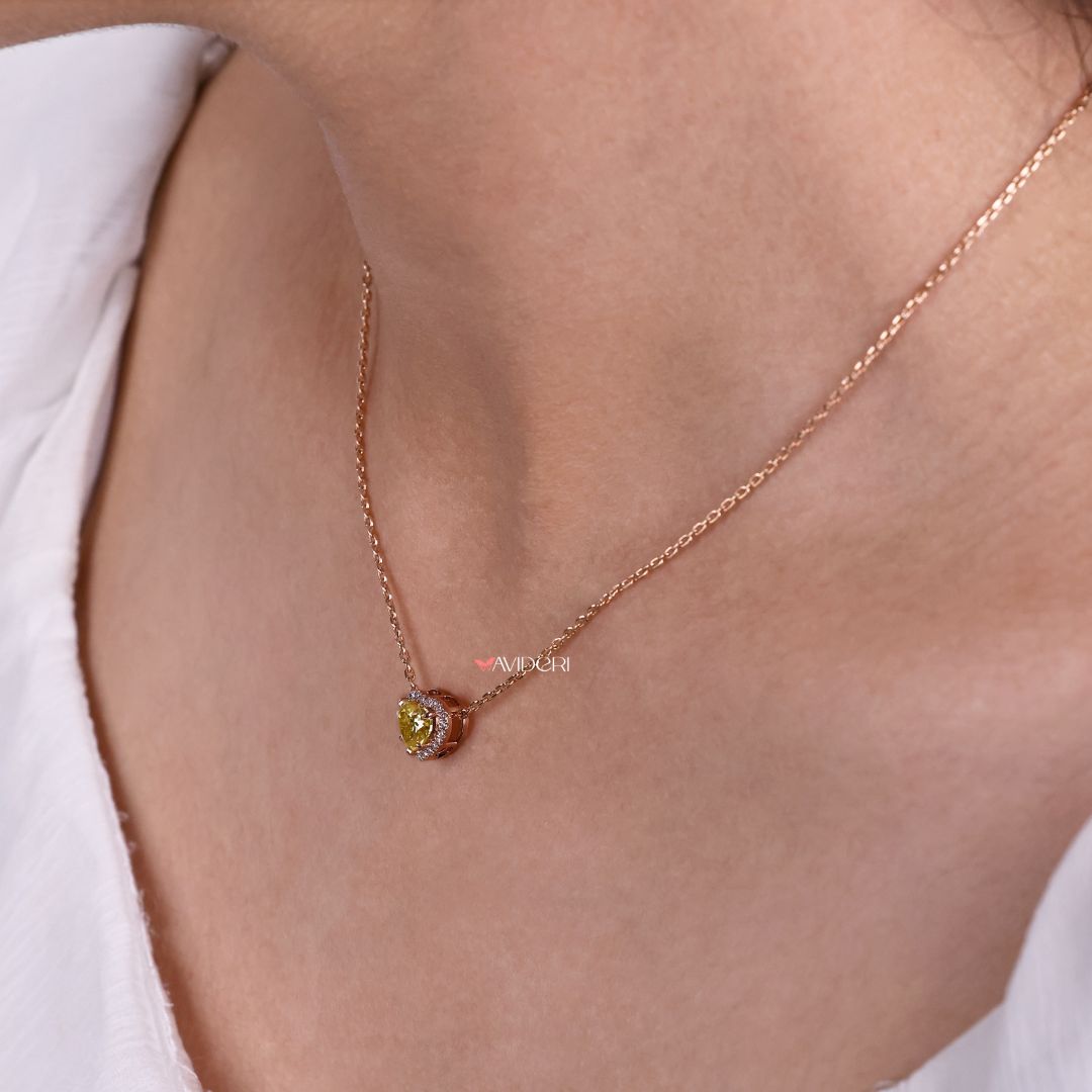 Handmade heart pendant with a round moissanite stone.