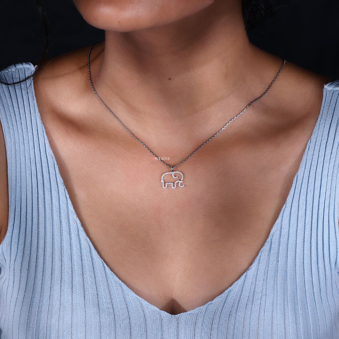 Moissanite pendant in a round gold setting.