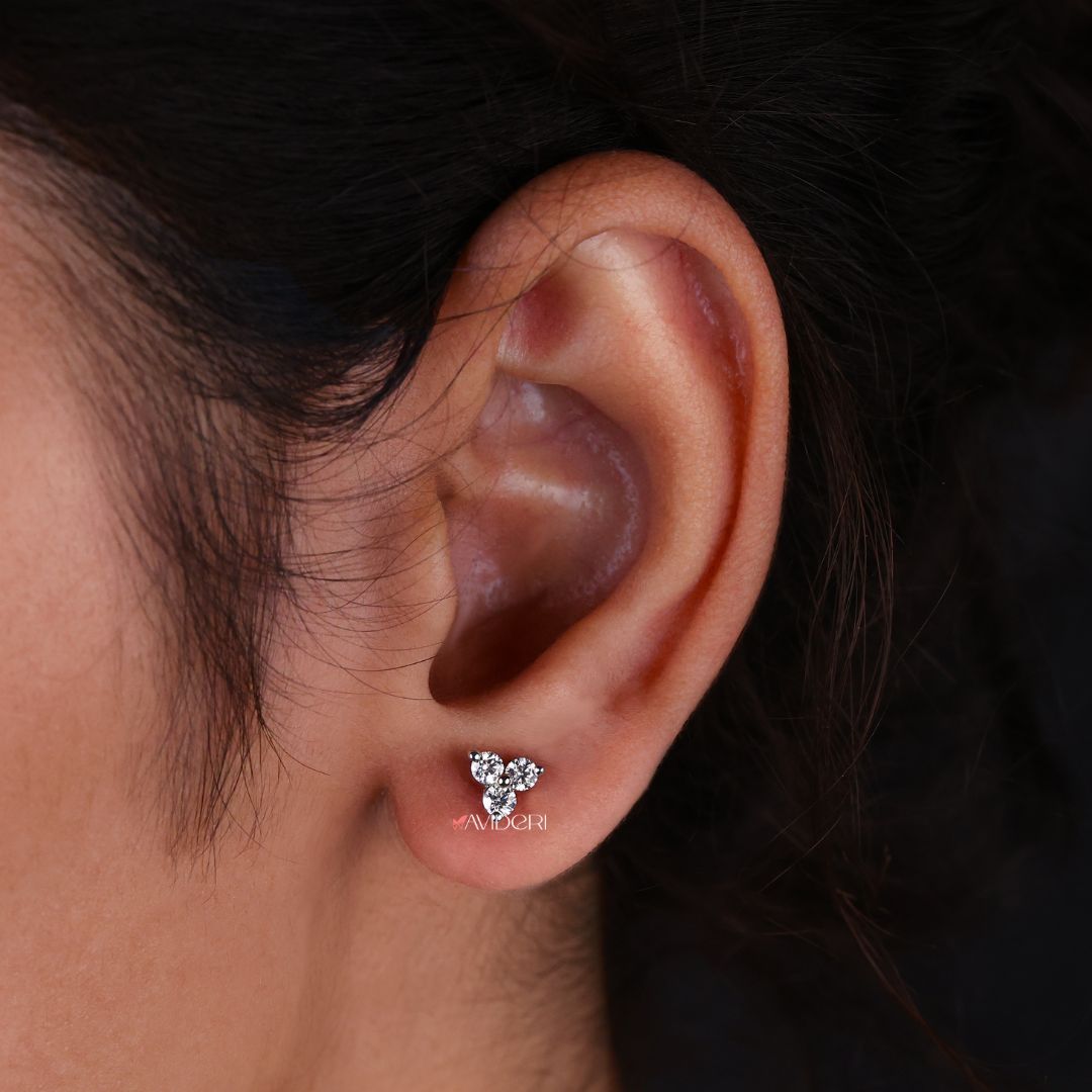 Round cut Moissanite earrings featuring three stone settings for a sparkling look.
