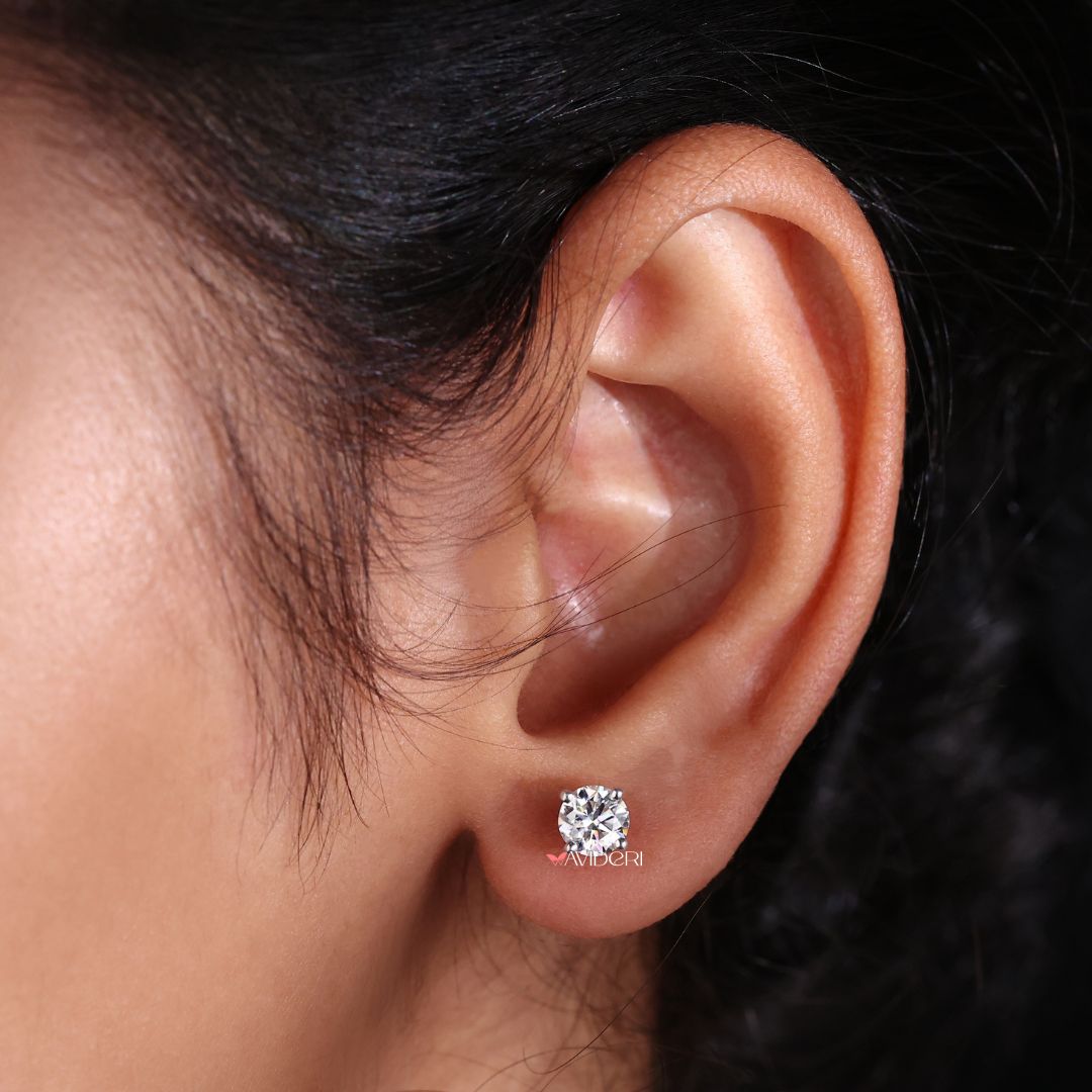 Round earrings with a soft white gold tone make a statement of subtle beauty and graceful charm.
