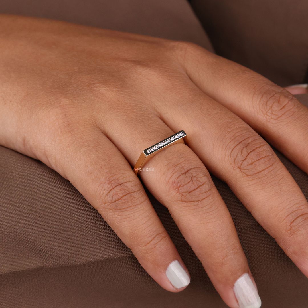 Channel setting wedding band enhances the brilliance of moissanite with continuous sparkle.