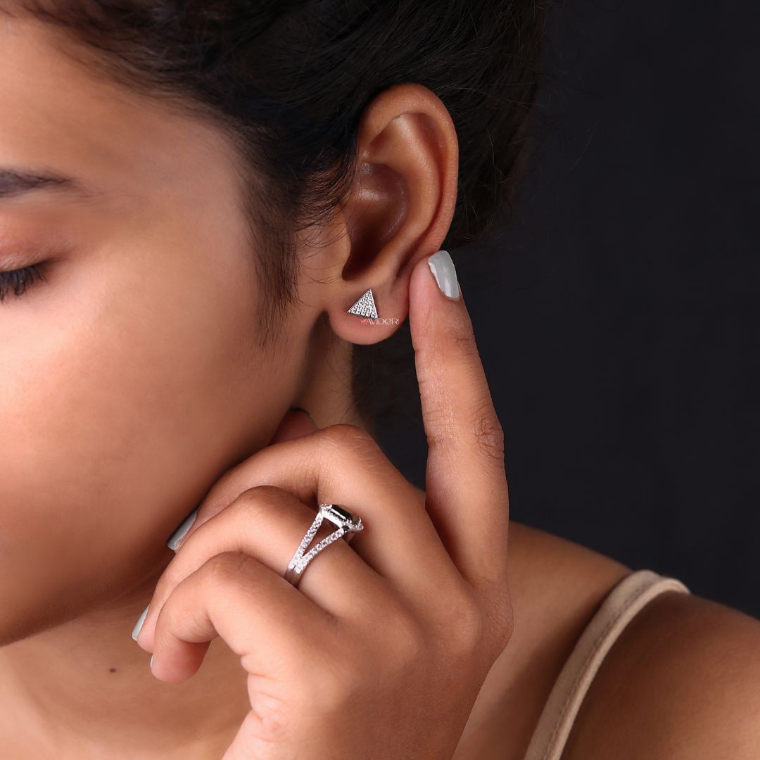 Handmade earrings with round cut stones set in a triangle shape.