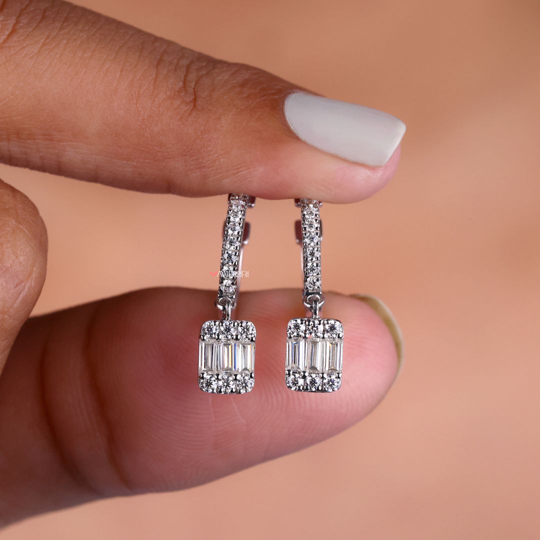 Baguette and round cut earrings in dangle drop style for a sophisticated look.