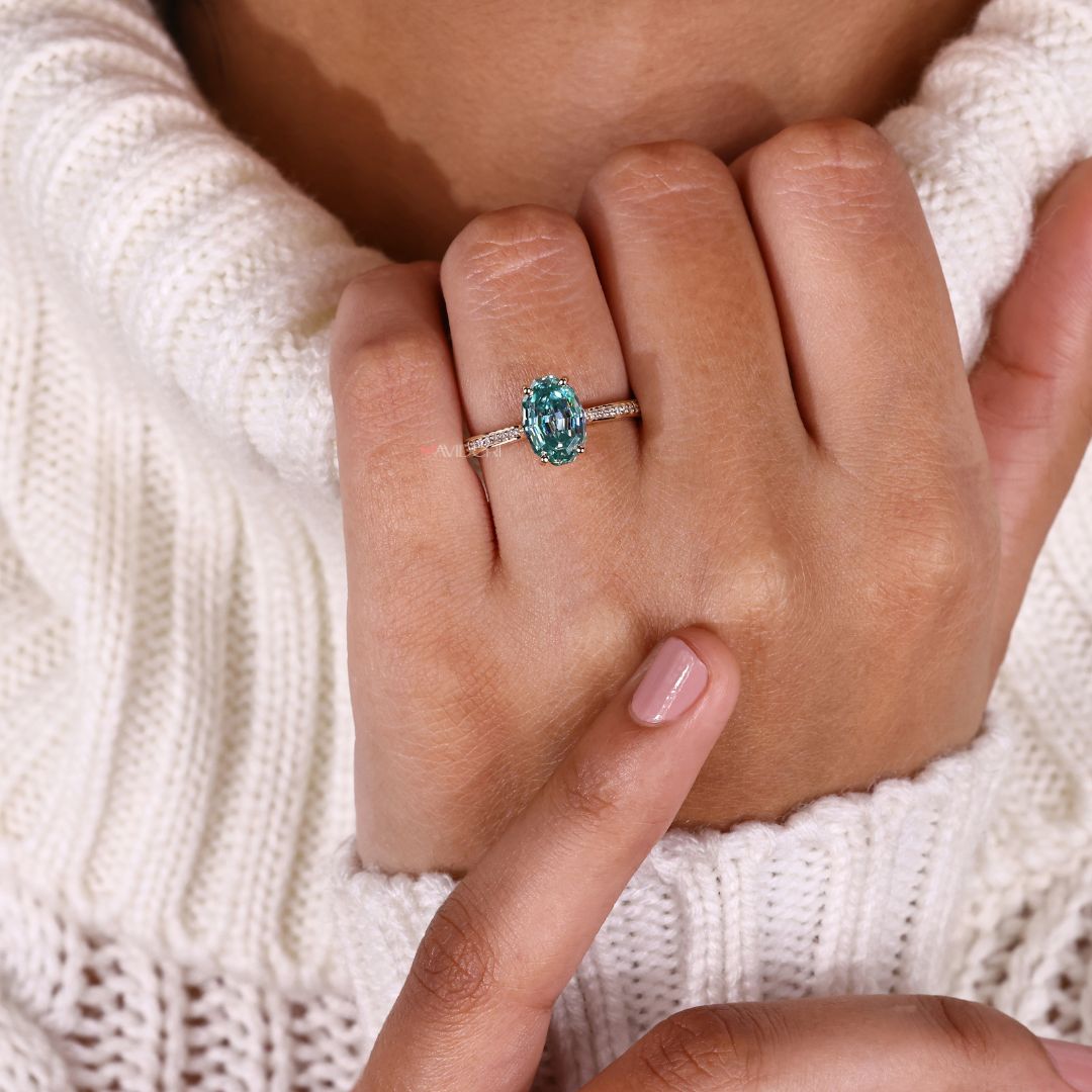 A beautiful handmade ring rests beside the bouquet.