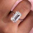 Emerald cut moissanite engagement ring with elegant design.
