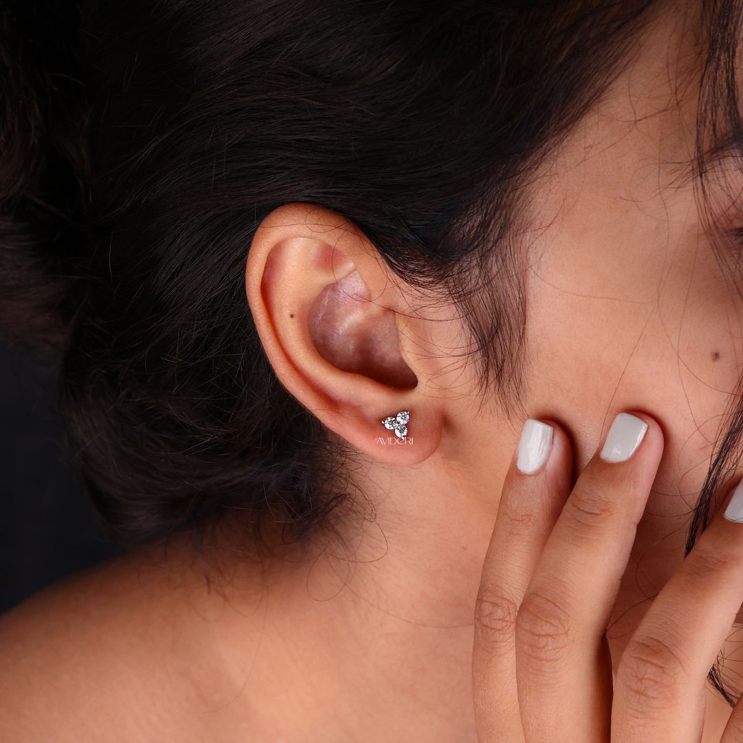 Prong settings earrings featuring round cut Moissanite in three stone design.