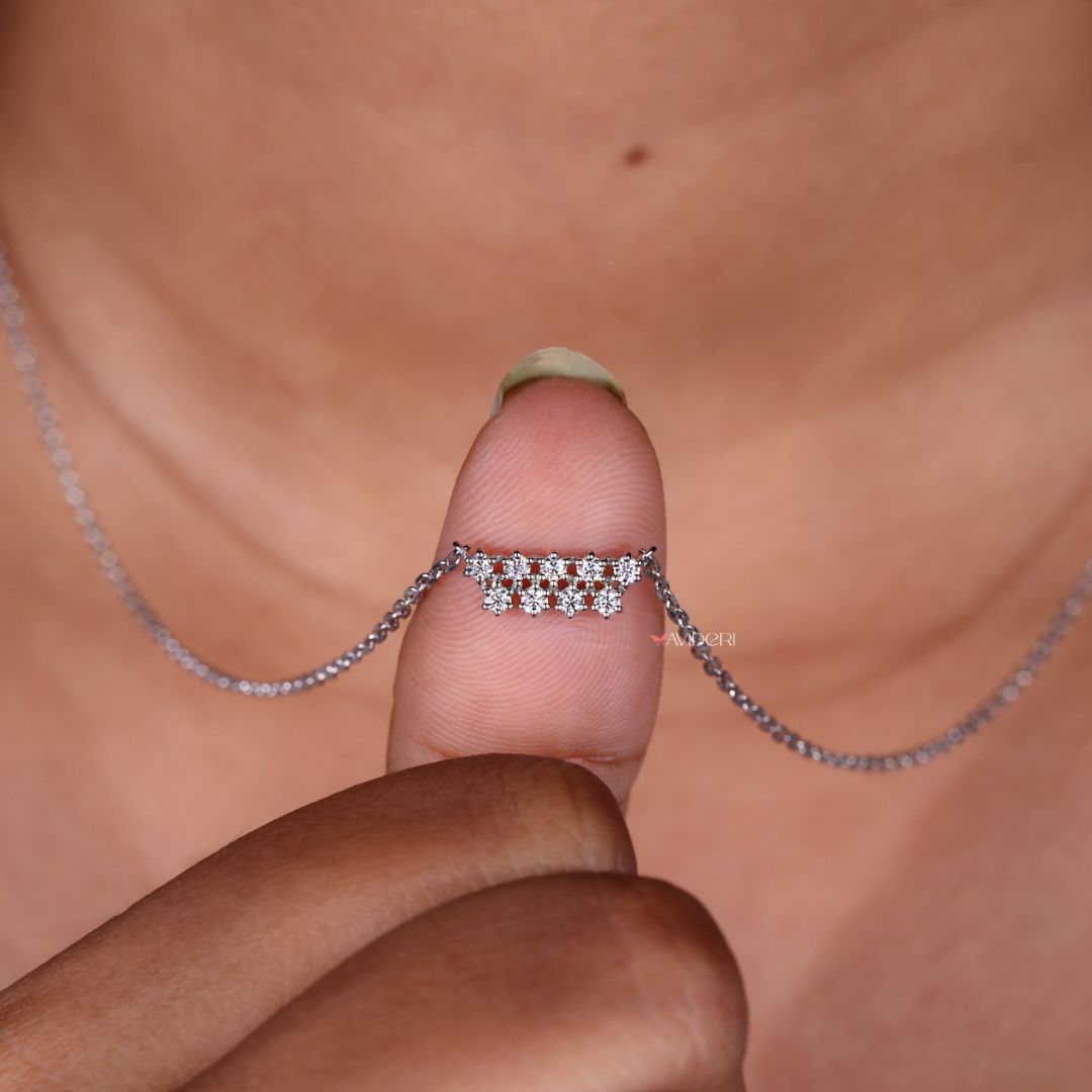 Round diamond pendant set in a classic bar design