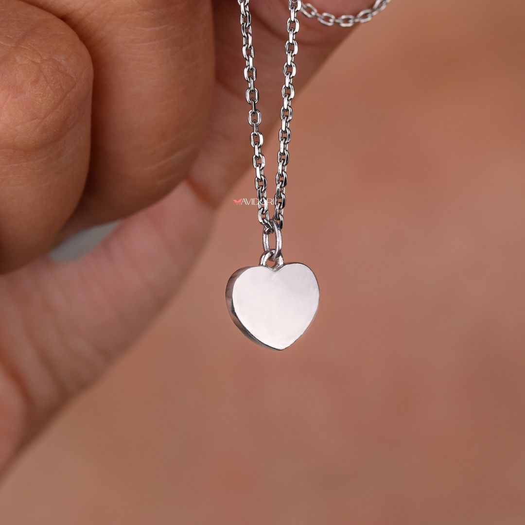 Customize pendant with a heart shape design and round moissanite stone.